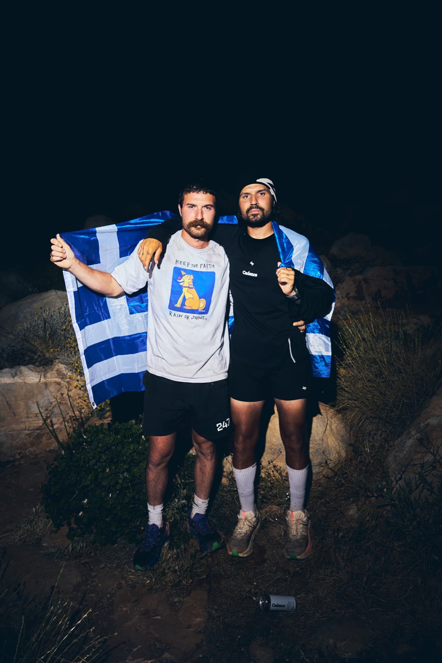 Lucas and his brother holding the Greek flag after the run