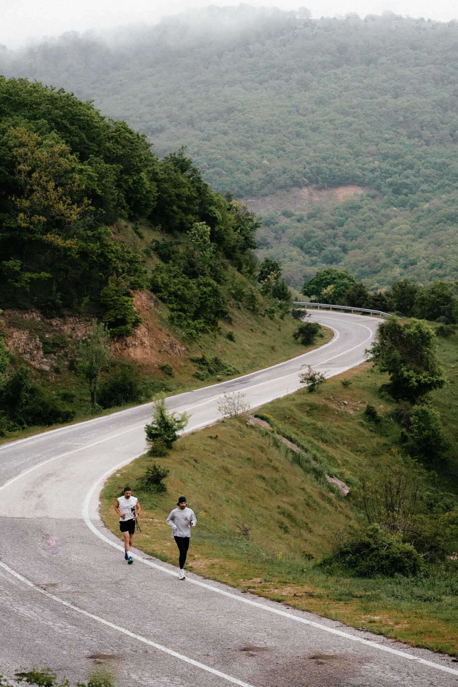 Lucas and his brother running on a mountain road in Greece